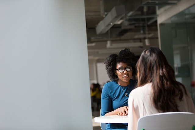 Two women in a white office, in an interview