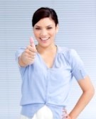 Woman is dressed in nice attire, simple blouse and skirt, she is showing some positive emotions with her gesture